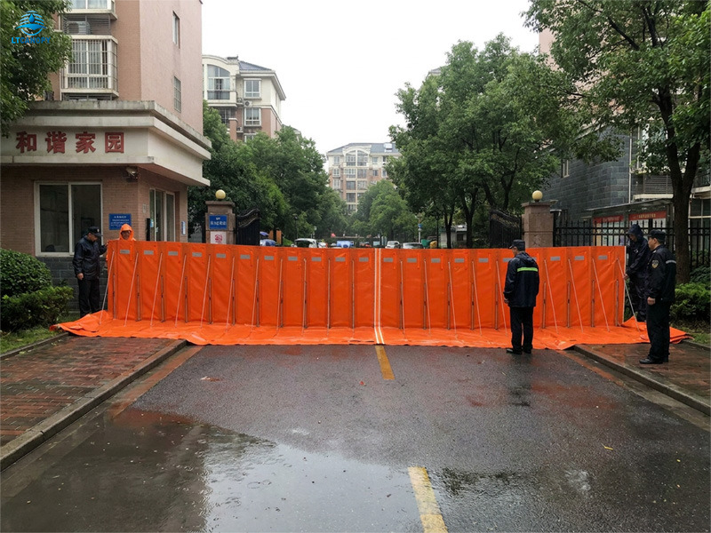 Residential community flood barrier for neighborhood entrance protection