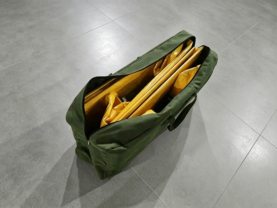 Folded PVC flood barrier packed in carry bag for space-efficient easy transport