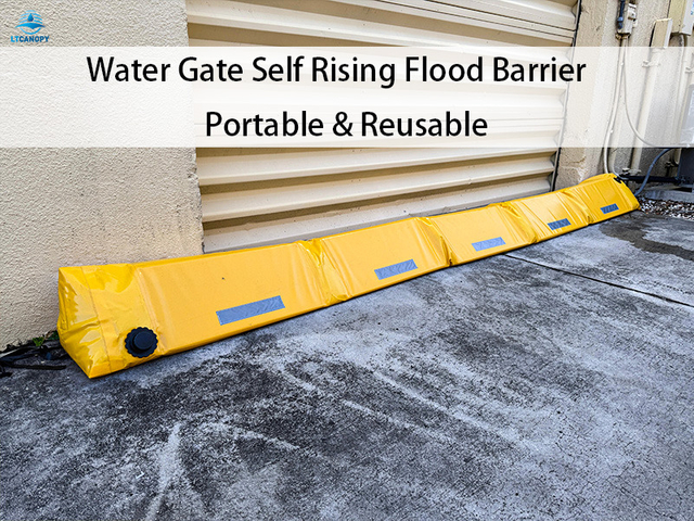 Yellow triangular water filled flood barrier installed at residential garage entrance